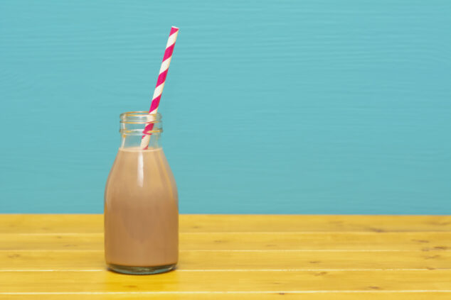 Dairy drinks Chocolate milkshake with a retro straw in a glass bottle