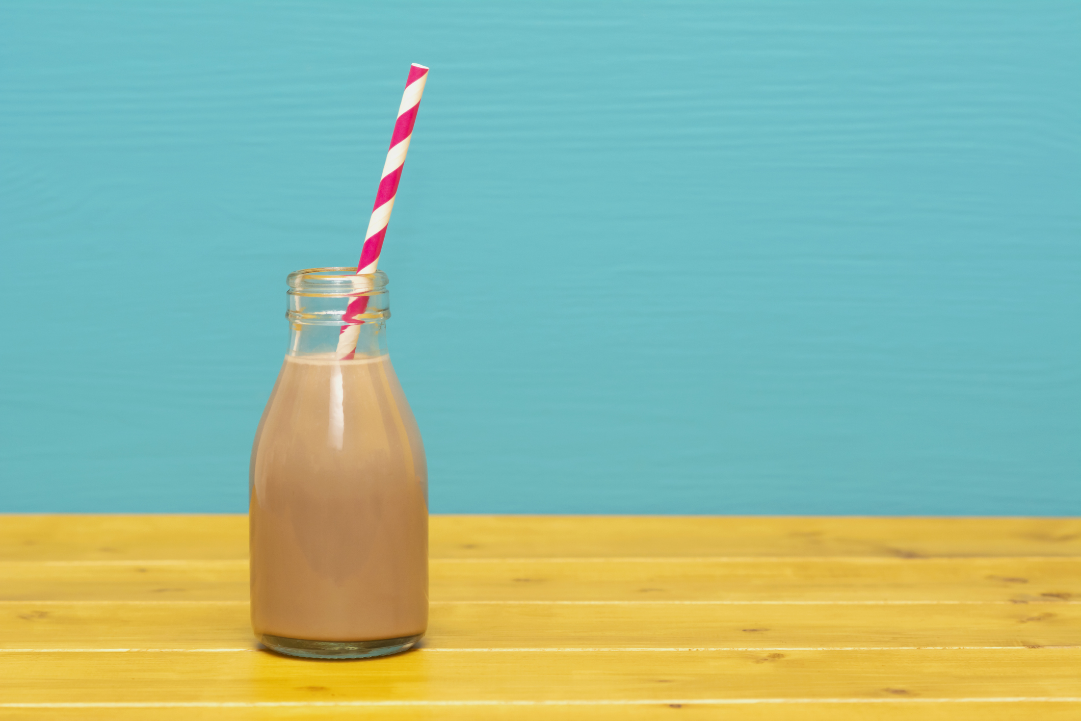 Dairy drinks Chocolate milkshake with a retro straw in a glass bottle