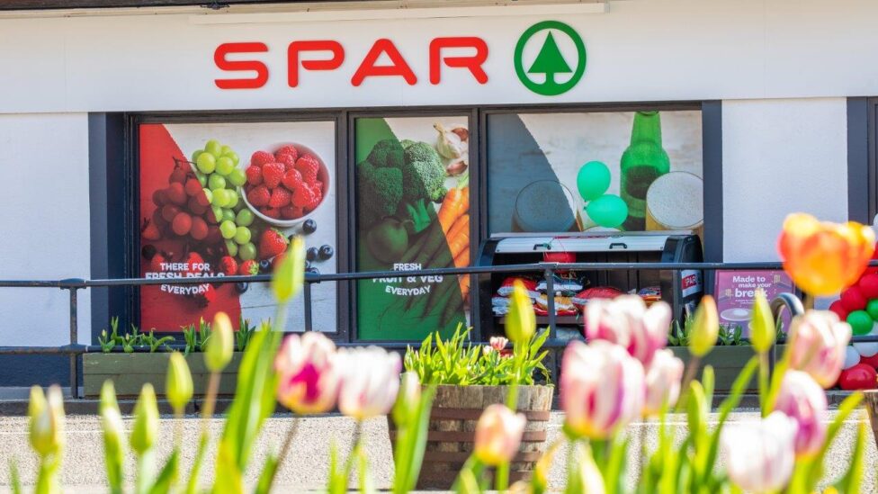 The exterior of a Drymen SPAR store with a row of tulip flowers in the foreground.